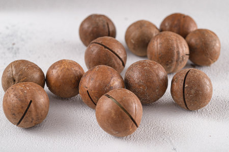 macadamia australian nuts scattered on white backgroundの写真素材