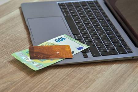 Internet payment concept, credit card and euro paper money on laptopの写真素材