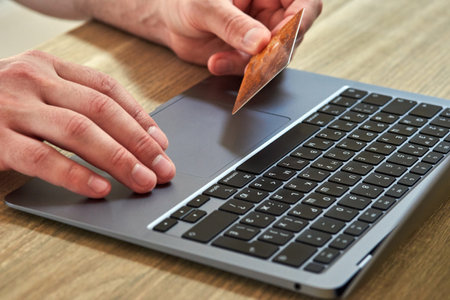 Online payment by credit card. hand with credit card and hand on keyboardの写真素材