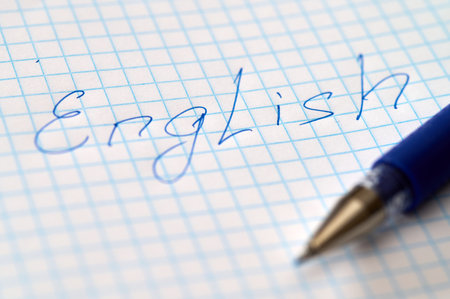 English word hand written on paper close-up. English language learning conceptの写真素材