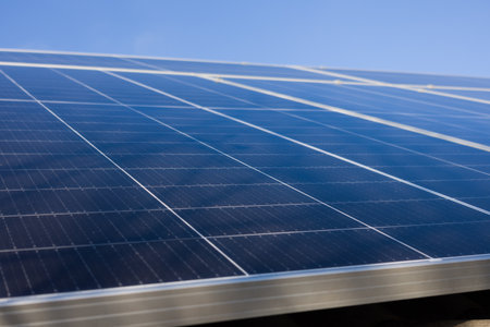 Close-up view of solar panels under a bright blue sky. Clean energy, sustainability concept.の写真素材