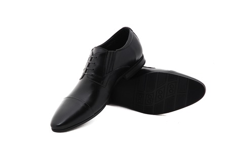 Black patent leather men shoes against white background. Male fashion with shoes on white.  The black mans shoes isolated on white background.の写真素材
