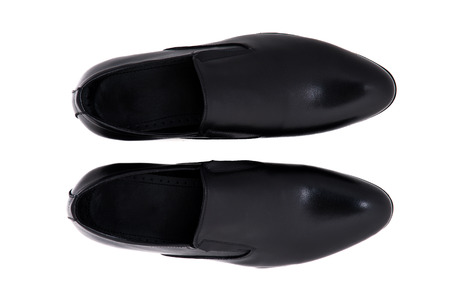Black patent leather men shoes against white background. Male fashion with shoes on white.  The black man's shoes isolated on white background.の写真素材