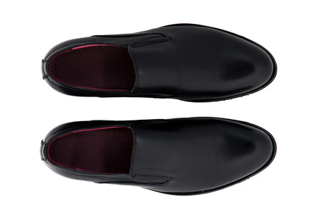 Black patent leather men shoes against white background. Male fashion with shoes on white.  The black man's shoes isolated on white background.の写真素材