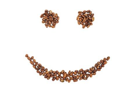 Grains of coffee in the form of smiling face isolated. coffee beans isolated on white background. roasted coffee beans, can be used as a background.の写真素材