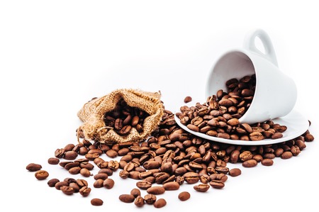 white cup with coffee beans isolatedの写真素材