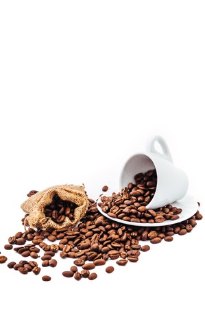 white cup with coffee beans isolatedの写真素材