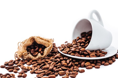 white cup with coffee beans isolatedの写真素材