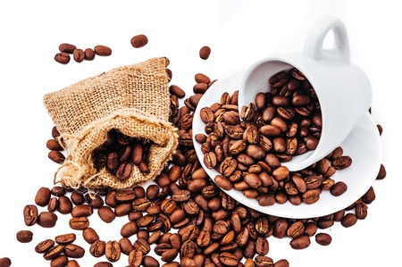 white cup with coffee beans isolatedの写真素材
