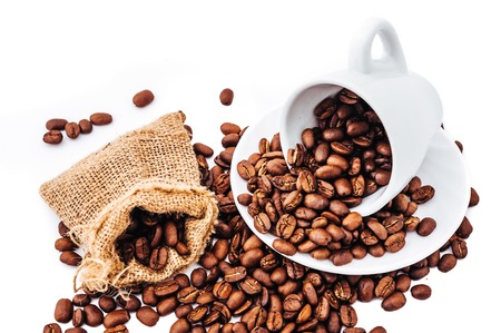 white cup with coffee beans isolatedの写真素材