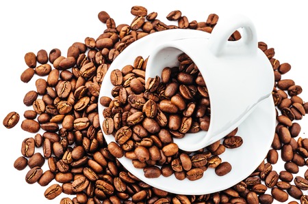 white cup with coffee beans isolatedの写真素材