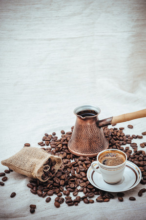 Coffee turk and roasted beans on burlap backgroundの写真素材