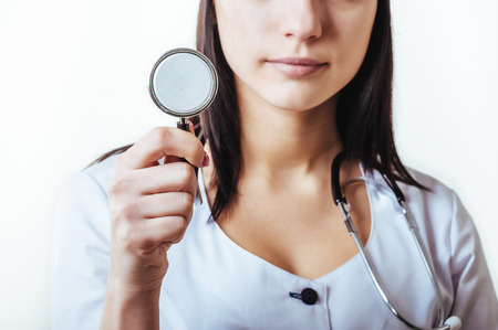 Smiling medical doctor woman with stethoscope. Isolated over white background.の写真素材