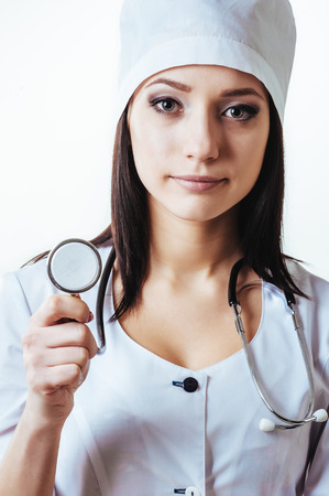 Smiling medical doctor woman with stethoscope. Isolated over white background.の写真素材