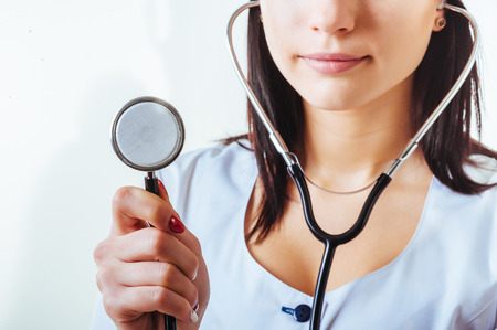 Smiling medical doctor woman with stethoscope. Isolated over white background.の写真素材