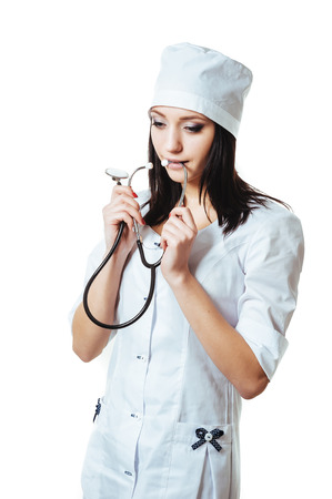 A female doctor with a stethoscope, standing isolated on white backgroundの写真素材