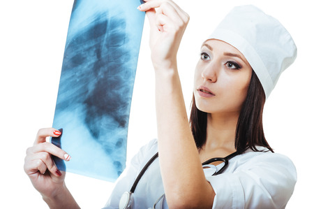 Female doctor looking at an x-ray,isolated on white background.の写真素材