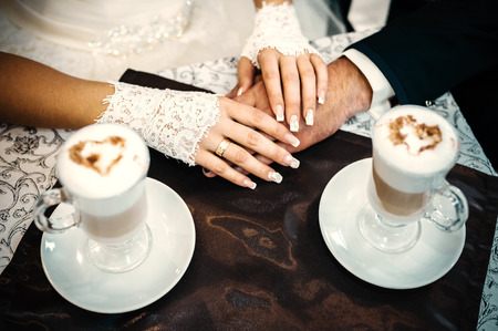 Love you honey.  Newly wed couple drinking cappuccino in cafeの写真素材