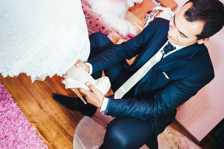 Newlyweds embraces. Young newlyweds kiss and enjoying romantic moment together at wedding dayの写真素材
