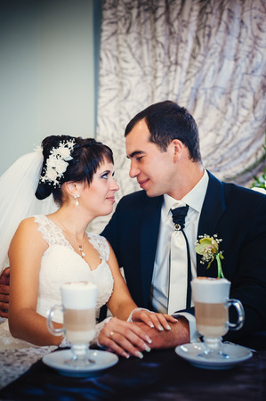 Love you honey.  Newly wed couple drinking cappuccino in cafeの写真素材