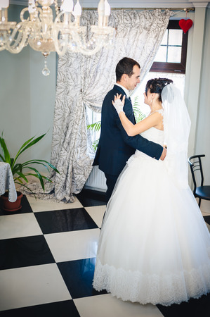 Wedding dance of charming bride and groom on their wedding celebration in a luxurious restaurant.の写真素材