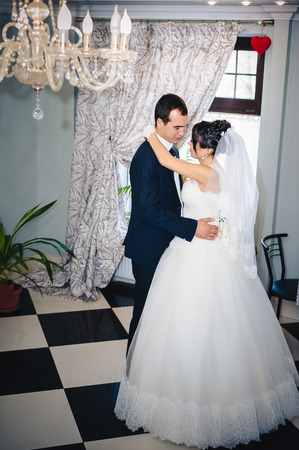 Wedding dance of charming bride and groom on their wedding celebration in a luxurious restaurant.の写真素材