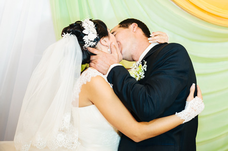 Charming bride and groom on their wedding celebration in a luxurious restaurantの写真素材