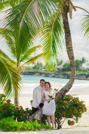 beautiful couple on the beach in wedding dress. young loving couple on tropical sea background - wedding on beachの写真素材