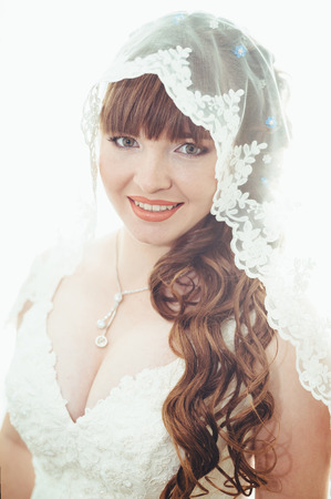 Beautiful Bride lit by sunlight from a window. の写真素材