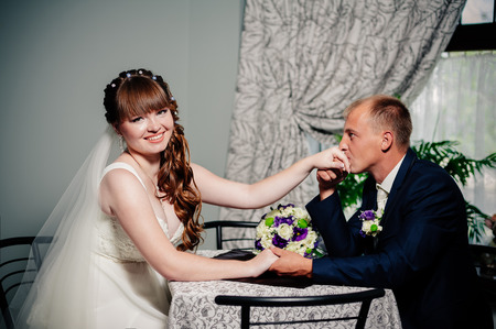 Charming bride and groom on their wedding celebration in a luxurious restaurantの写真素材
