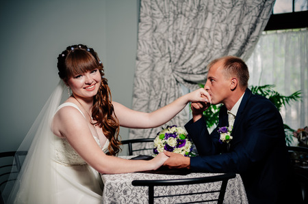 Charming bride and groom on their wedding celebration in a luxurious restaurantの写真素材