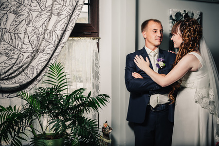 Charming bride and groom on their wedding celebration in a luxurious restaurantの写真素材