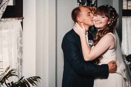 Charming bride and groom on their wedding celebration in a luxurious restaurantの写真素材