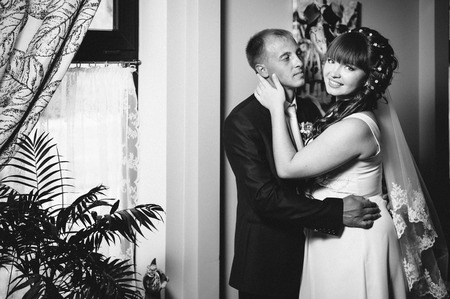 Charming bride and groom on their wedding celebration in a luxurious restaurantの写真素材