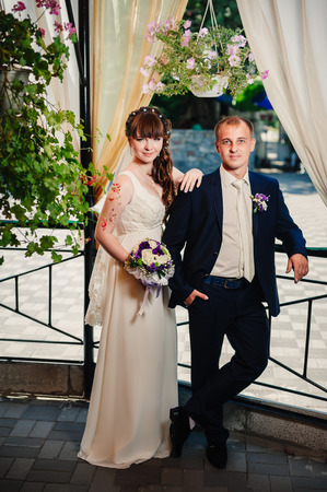 young bride and groom in the park, a wedding bouquet, wedding dresses.の写真素材
