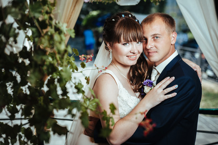young bride and groom in the park, a wedding bouquet, wedding dresses.の写真素材
