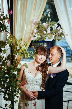 young bride and groom in the park, a wedding bouquet, wedding dresses.の写真素材