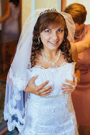 Beautiful caucasian bride getting ready for the wedding ceremony.の写真素材