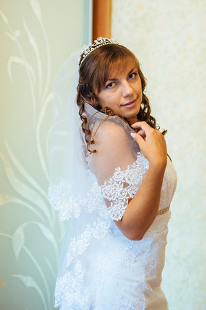 Beautiful caucasian bride getting ready for the wedding ceremony.の写真素材