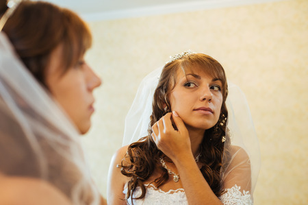 Beautiful caucasian bride getting ready for the wedding ceremony.の写真素材