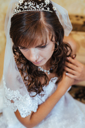 Beautiful caucasian bride getting ready for the wedding ceremony.の写真素材