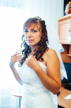 Beautiful caucasian bride getting ready for the wedding ceremony.の写真素材