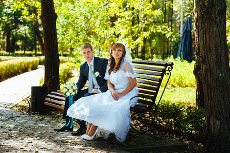 Bride and Groom at wedding Day walking Outdoors on spring nature. Bridal couple, Happy Newlywed woman and man embracing in green park. Loving wedding couple outdoor.の写真素材