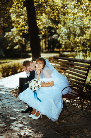 Bride and Groom at wedding Day walking Outdoors on spring nature. Bridal couple, Happy Newlywed woman and man embracing in green park. Loving wedding couple outdoor.の写真素材