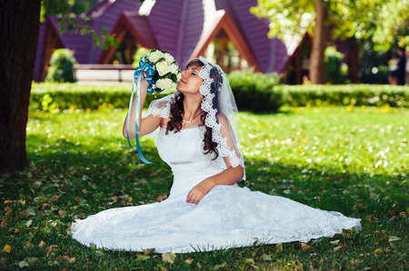 Portrait of a beautiful smiling bride posing in her wedding day.の写真素材