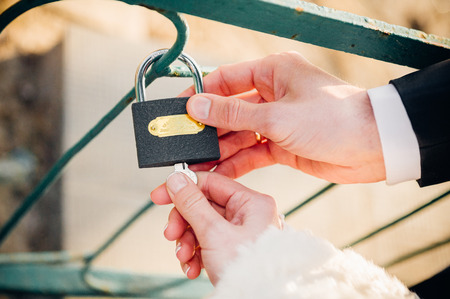 A wedding by the sea. Honeymoon. The bride and groom hugging on the shore of Lake. groom and bride hugging on a green lake. Groom and Bride in a park. wedding dress. Bridal wedding bouquet of flowersの写真素材