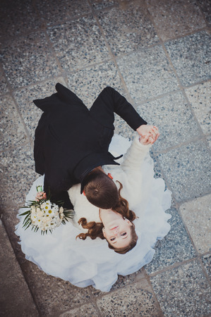 Elegant bride and groom posing together outdoors on a wedding day.の写真素材