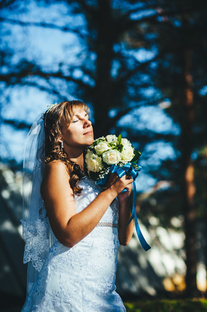 Portrait of a beautiful smiling bride posing in her wedding day.の写真素材