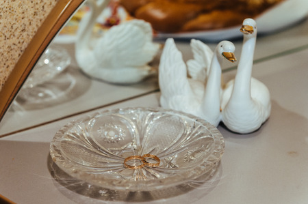two gold wedding rings on the decoration crystal plateの写真素材