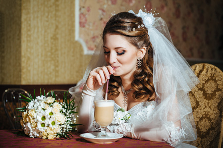 Cappuccino or latte coffee with heart shape. bride and groom  in a luxurious restaurant drink a cup of Coffee latte on the date. Coffee latte with heart design on their wedding or Valentines dayの写真素材